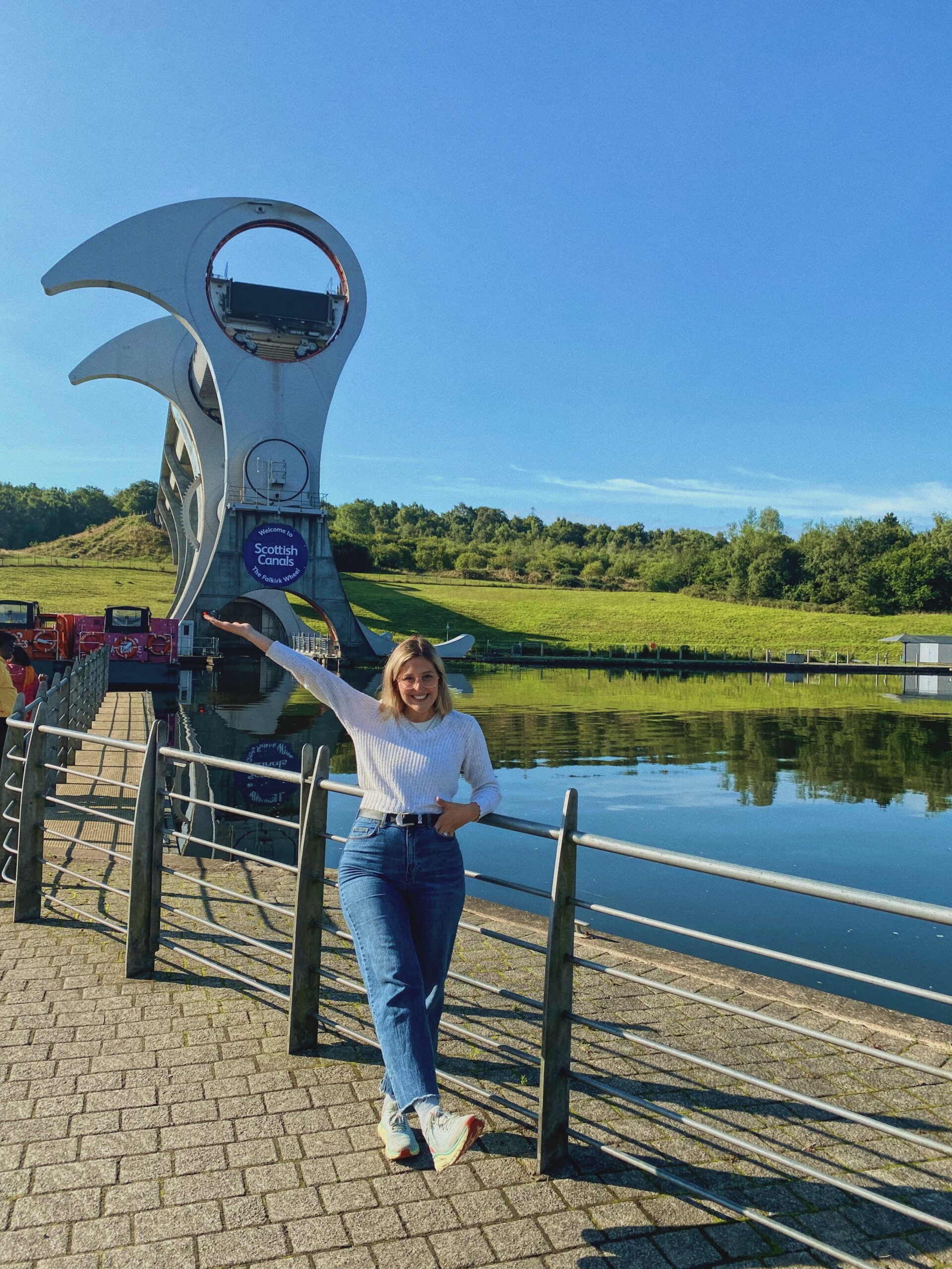 A woman stands in front of the Falkirk Wheel 
